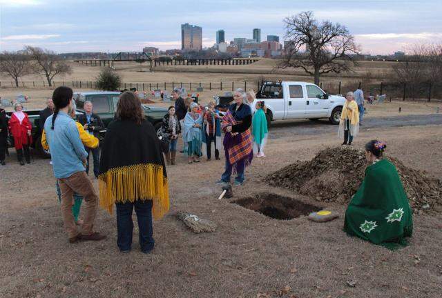 A plot in Oakwood Cemetery with a view of Fort Worth’s skyline is the burial site for the remains of a young Native American woman, found in 2016 at a construction site in downtown. Kui Red Eagle of Oklahoma, right, watches over the remains prior to a brief ceremony on Dec. 21, 2017.